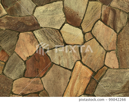 A background image of a light ocher rough and irregular paving stone surface A background image of a light ocher rough and irregular paving stone surface 99842266
