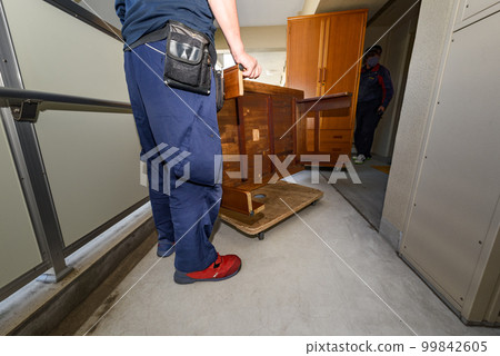 Moving work of an apartment house Transporting a table with a flat trolley 99842605