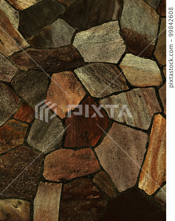 Vertical background image of a dark ocher rough paving stone surface Vertical background image of a dark ocher rough paving stone surface 99842608