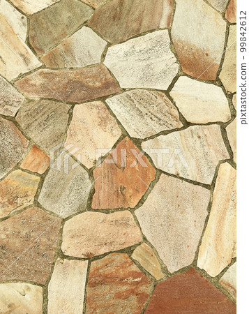 Vertical background image of the surface of paving stones of light ocher color 99842612