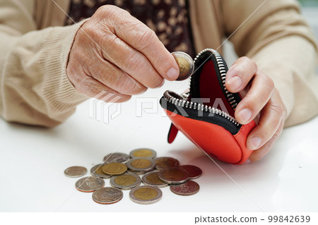 Retired elderly woman counting coins money and worry about monthly expenses and treatment fee payment. Retired elderly woman counting coins money and worry about monthly expenses and treatment fee payment. 99842639