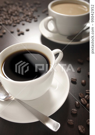 Coffee cup with roasted coffee beans on dark background Coffee cup with roasted coffee beans on dark background 99842952