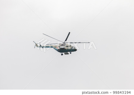 Mil Mi-17 military Russian helicopter flies in cloudy sky Mil Mi-17 military Russian helicopter flies in cloudy sky 99843194
