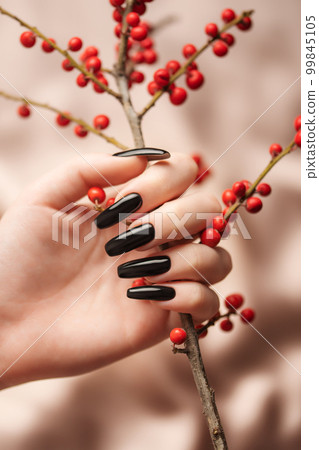 Hands of a young girl with black  manicure on nails 99845105