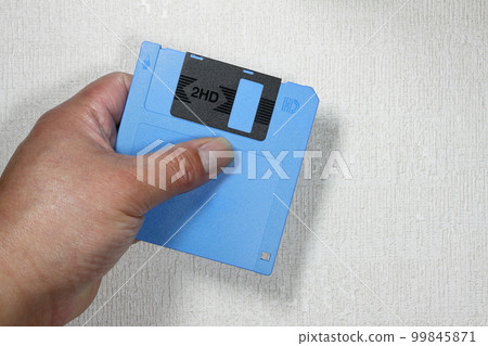 floppy disk in hand 99845871
