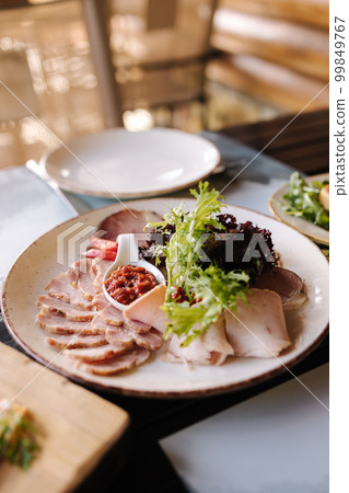 A traditional Ukrainian snack, sliced shovdar with adjika sauce 99849767