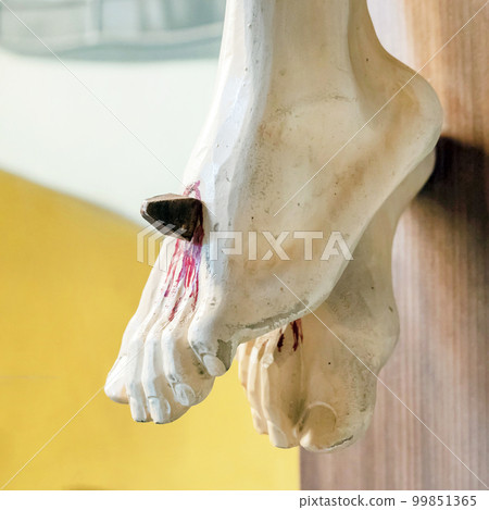 Nailed feet of Jesus 99851365