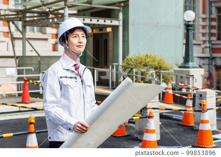 Site supervisor checking drawings at the construction site Site supervisor checking drawings at the construction site 99853896