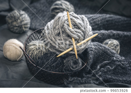 Composition with gray threads for knitting, yarn close-up. 99853926