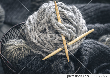 Composition with gray threads for knitting, yarn close-up. 99853927