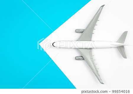 A plane, airplane on a blue background, flat lay, copy space. A plane, airplane on a blue background, flat lay, copy space. 99854016