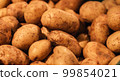 Raw dirty potatoes in the supermarket, close-up. 99854021