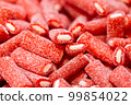 Red gummies covered with sugar, candy background. 99854022