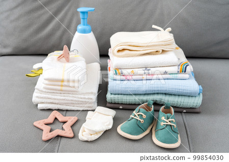 Set of diapers and kids stuff for little baby on a couch. Newborn baby concept 99854030