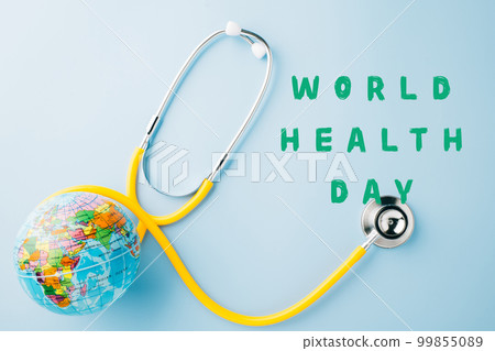 World Health Day. Yellow doctor stethoscope and world globe isolated on blue background, Save world day, Green Earth, Healthcare and medical concept World Health Day. Yellow doctor stethoscope and world globe isolated on blue background, Save world day, Green Earth, Healthcare and medical concept 99855089