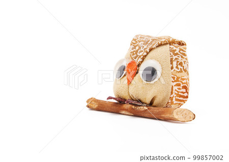 Owl figurine perched on a tree Owl figurine perched on a tree 99857002