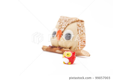 Owl figurine perched on a tree Owl figurine perched on a tree 99857003