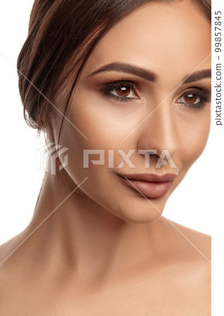 Close up portrait of a brunette nude model girl with professional evening make-up and plump lips, posing isolated on white background. Close up portrait of a brunette nude model girl with professional evening make-up and plump lips, posing isolated on white background. 99857845