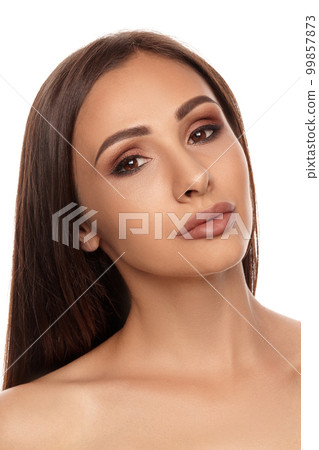 Close up portrait of a brunette nude model girl with professional evening make-up and plump lips, posing isolated on white background. 99857873