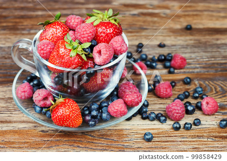 Mix of berries in a a transparent cup Mix of berries in a a transparent cup 99858429