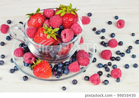 Mix of berries in a a transparent cup Mix of berries in a a transparent cup 99858430