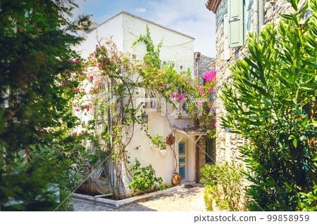 Narrow street in old town of Marmaris, Turkey . Beautiful scenic old ancient white houses with flowers. Narrow street in old town of Marmaris, Turkey . Beautiful scenic old ancient white houses with flowers. 99858959