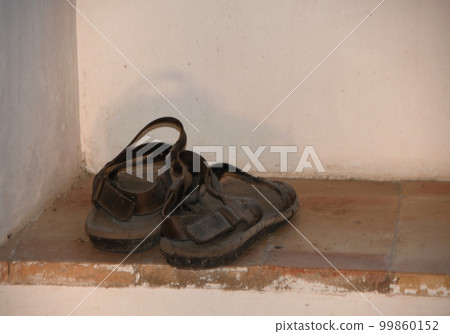 The old monk sandals in a window The old monk sandals in a window 99860152