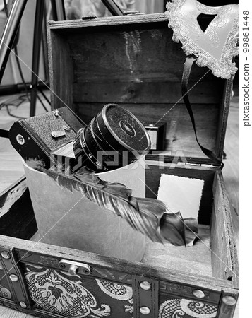 an old SLR camera in a frame and in a chest 99861448
