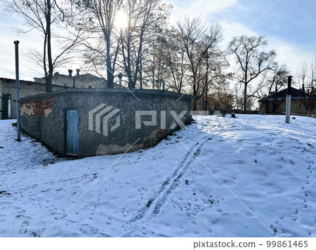 city courtyard in winter - entrance to the old basement underground 99861465