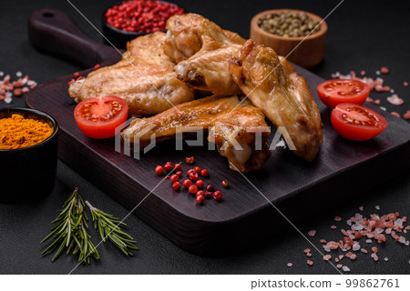 Baked chicken wings with salt, spices and herbs Baked chicken wings with salt, spices and herbs 99862761