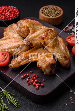 Baked chicken wings with salt, spices and herbs Baked chicken wings with salt, spices and herbs 99862762