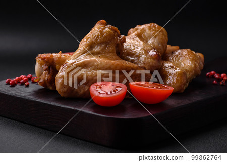 Baked chicken wings with salt, spices and herbs Baked chicken wings with salt, spices and herbs 99862764