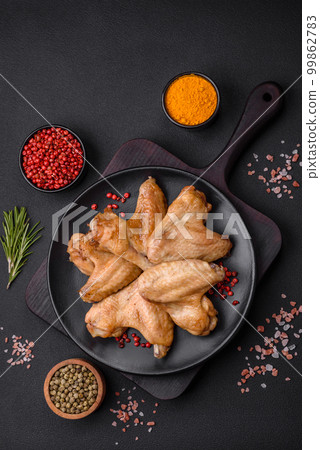 Baked chicken wings with salt, spices and herbs Baked chicken wings with salt, spices and herbs 99862783
