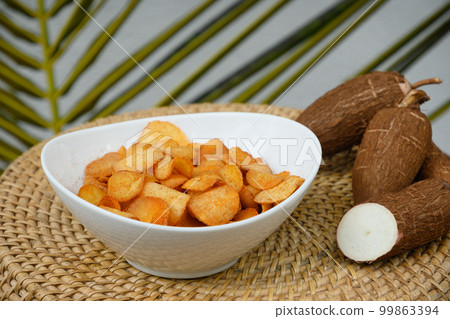Organic Cassava chips in bowl. Indonesia popular hot spicy snacks. Close up. 99863394