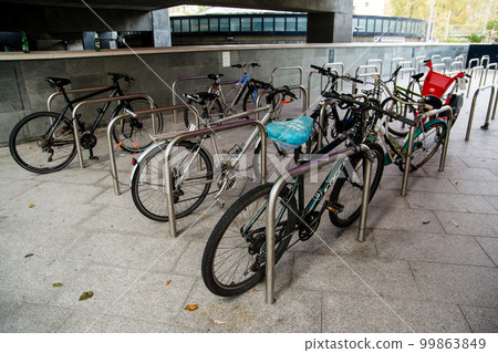 A bicycle parked in a bicycle parking lot lined with pipes, near Paddington Station in London A bicycle parked in a bicycle parking lot lined with pipes, near Paddington Station in London 99863849