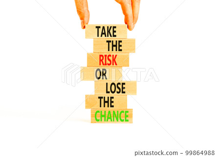 Risk or chance symbol. Concept words Take the risk or lose the chance on wooden blocks. Beautiful white background. Copy space. Businessman hand. Motivational business risk or chance concept. 99864988