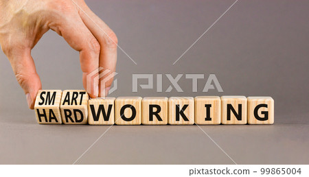 Smart or hard working symbol. Concept words Smart working and Hard working on wooden cubes. Businessman hand. Beautiful grey table grey background. Business smart hard working concept. Copy space. Smart or hard working symbol. Concept words Smart working and Hard working on wooden cubes. Businessman hand. Beautiful grey table grey background. Business smart hard working concept. Copy space. 99865004
