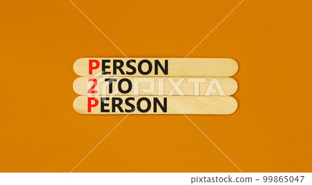 P2P person to person symbol. Concept words P2P person to person on wooden stick on a beautiful orange table orange background. Business and P2P person to person concept. Copy space. 99865047
