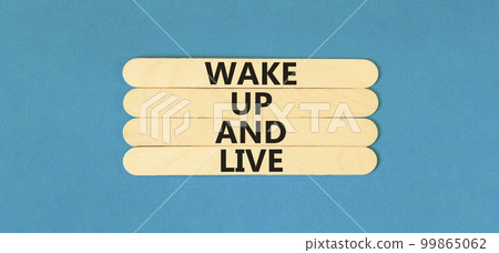 Wake up and live symbol. Concept words Wake up and live on wooden stick. Beautiful blue table blue background. Business lifestyle wake up and live concept. Copy space. Wake up and live symbol. Concept words Wake up and live on wooden stick. Beautiful blue table blue background. Business lifestyle wake up and live concept. Copy space. 99865062