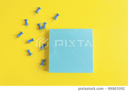 Push pins on a yellow background. Sheet for notes and stationery pins.. office background with copy space 99865092