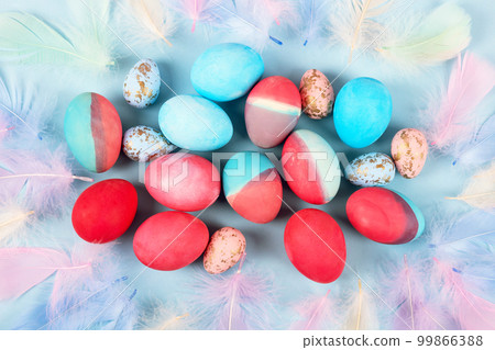 Painted Easter eggs in crimson and blue on a blue background with a place for text. Happy Easter concept. Greeting card, copy space 99866388
