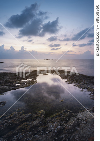 reflection of water, sunset on the seashore and rocks, kaolak phuket thailand, Nang tong beach vertical photography 99868960