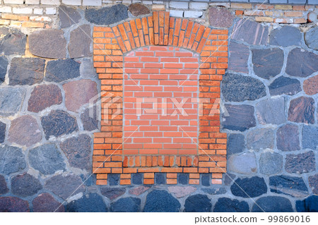 stone masonry wall with bricked up window with red bricks stone masonry wall with bricked up window with red bricks 99869016