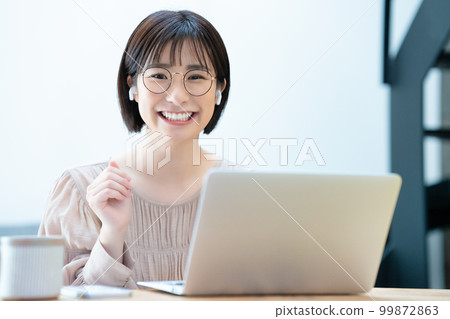 A woman with glasses enjoying an online girls' association 99872863