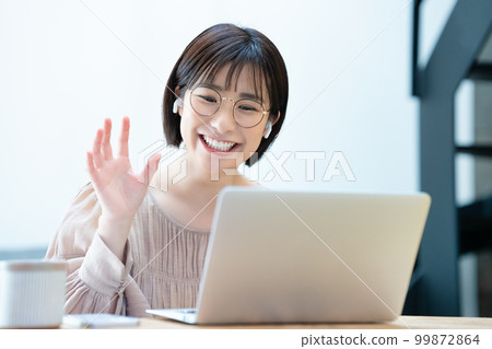 A woman with glasses enjoying an online girls' association 99872864