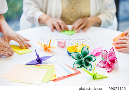 A senior woman folding origami and a caregiver Photography cooperation "LINK FOREST" A senior woman folding origami and a caregiver Photography cooperation "LINK FOREST" 99873133