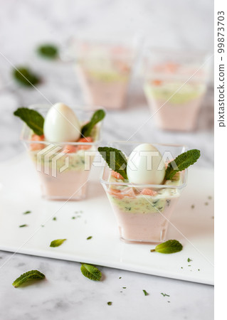 Salmon and cream mousse decorated with mint leaves, Easter appetizer 99873703