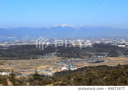 The snow-capped Hira Mountains on the opposite shore of Lake Biwa seen from the mountain trail of Doyama in the Konan Alps The snow-capped Hira Mountains on the opposite shore of Lake Biwa seen from the mountain trail of Doyama in the Konan Alps 99875877