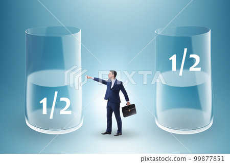 Businessman in half empty half full glass concept Businessman in half empty half full glass concept 99877851
