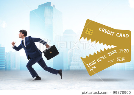 Businessman in credit card debt concept Businessman in credit card debt concept 99878900